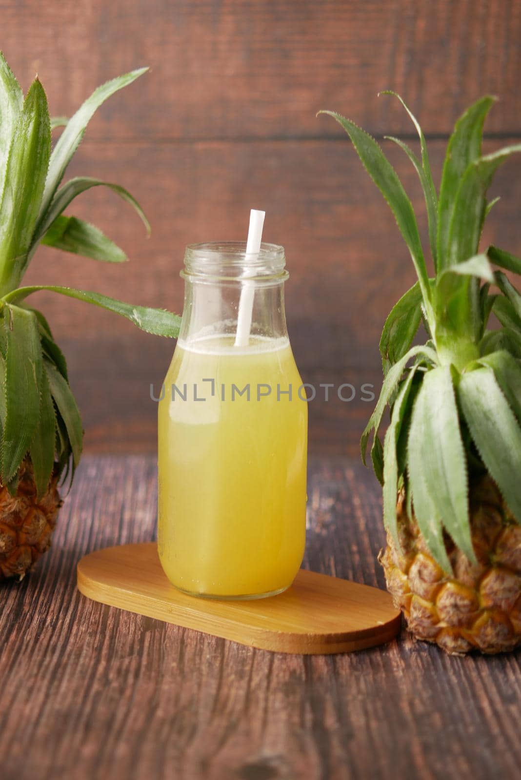 pineapple juice in a bottle on table by towfiq007