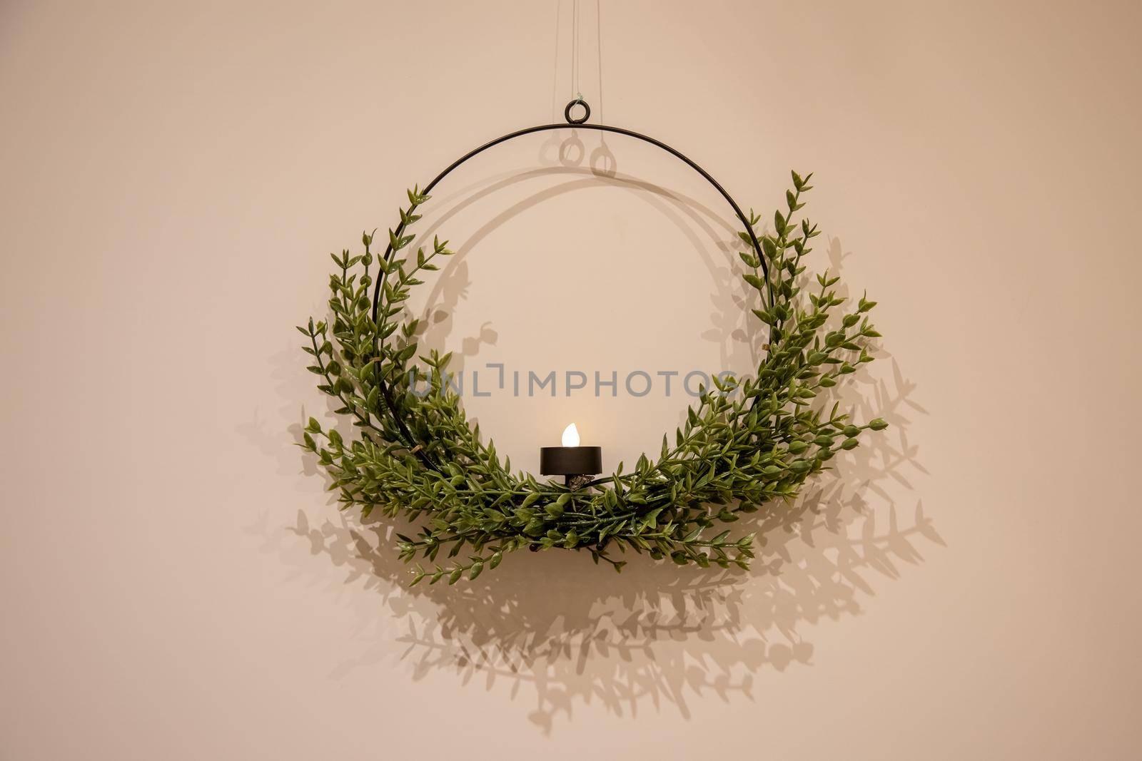 beautiful Christmas candlestick wreath on a light wall by Mariaprovector