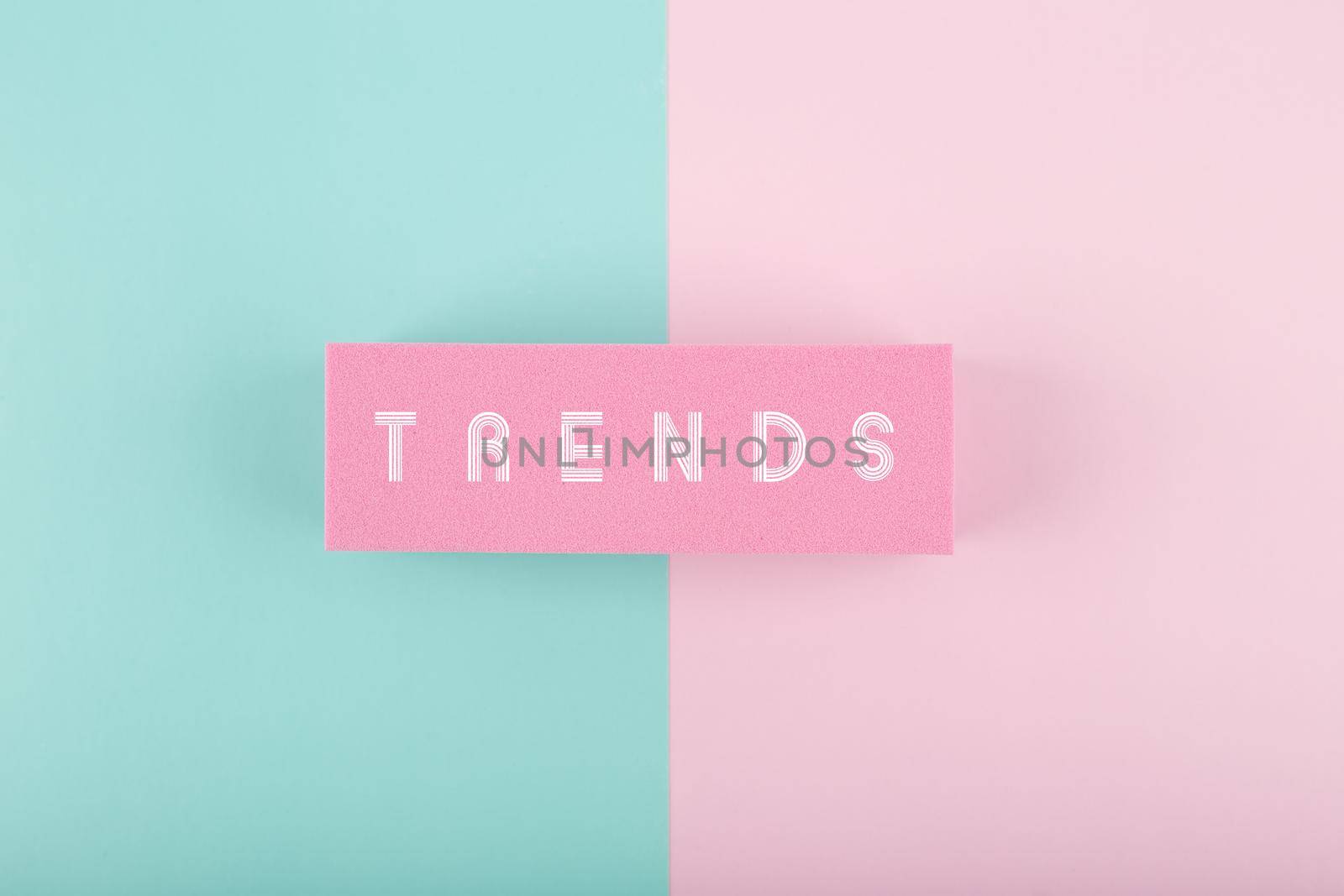 Trends written on rectangle in the middle of multicolored light blue and pink background. Minimal concept of newest, latest, hot and popular trends of any industry