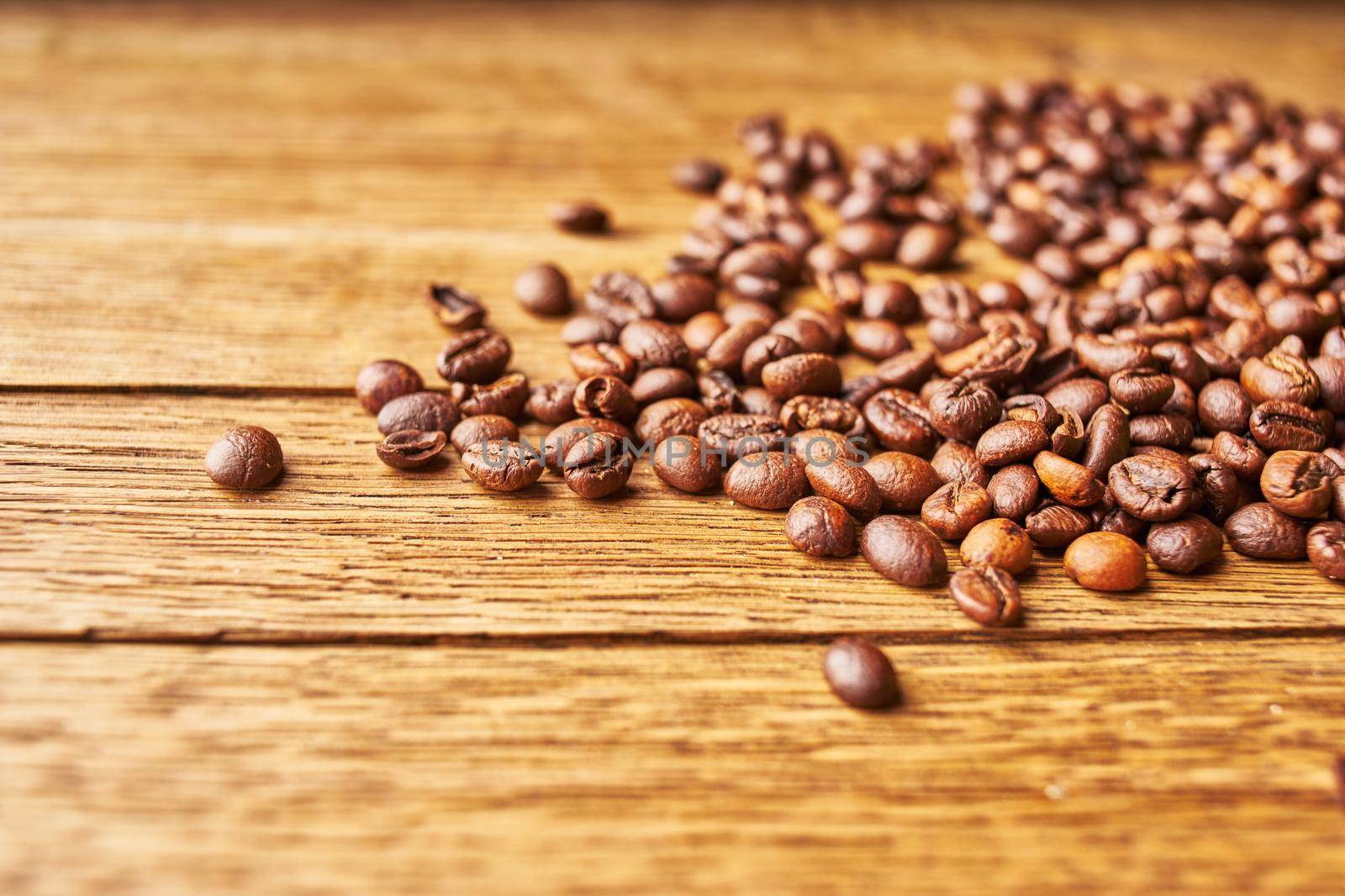 coffee beans Hot drink spilled grains wood background. High quality photo