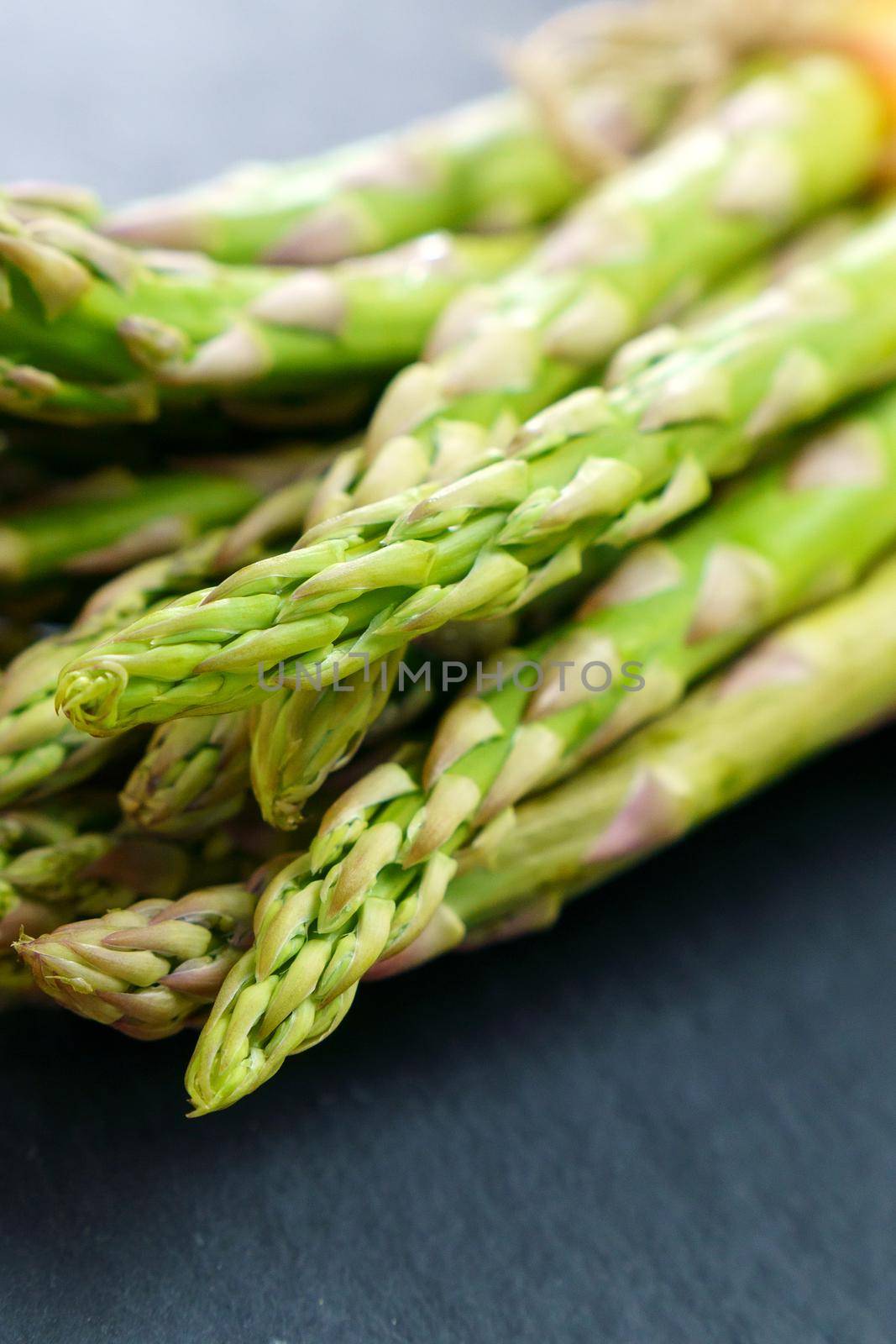 Fresh of green Asparagus. Cooking healthy meal. Bunches of green asparagus. Selective focus. Vertical photo by darksoul72