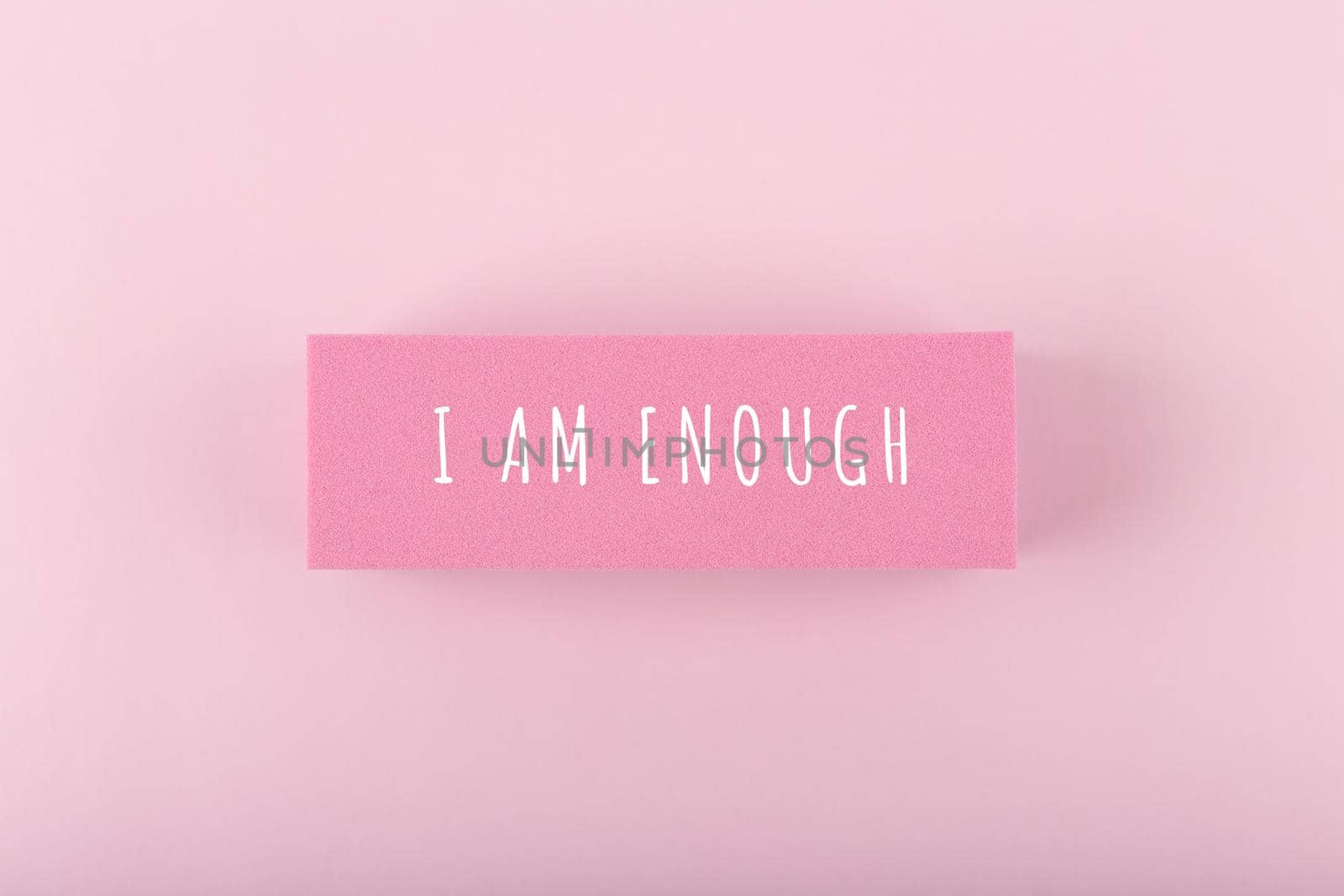 I am enough concept. Hand written text on bright pink background by Senorina_Irina