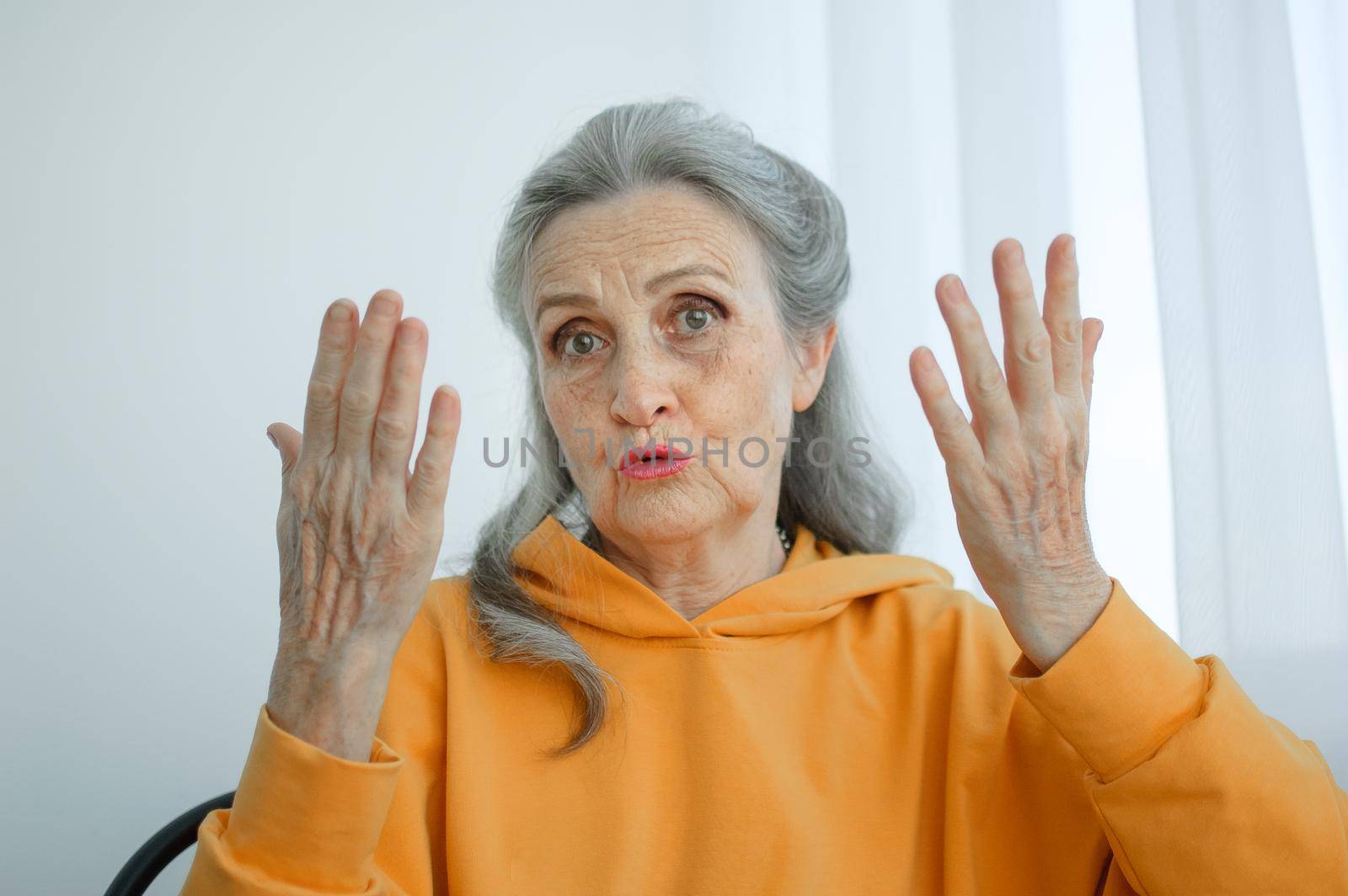 Closeup portrait of angry upset senior mature woman talking with someone and looking at the camera. Negative emotion, facial expression, scandal by balinska_lv