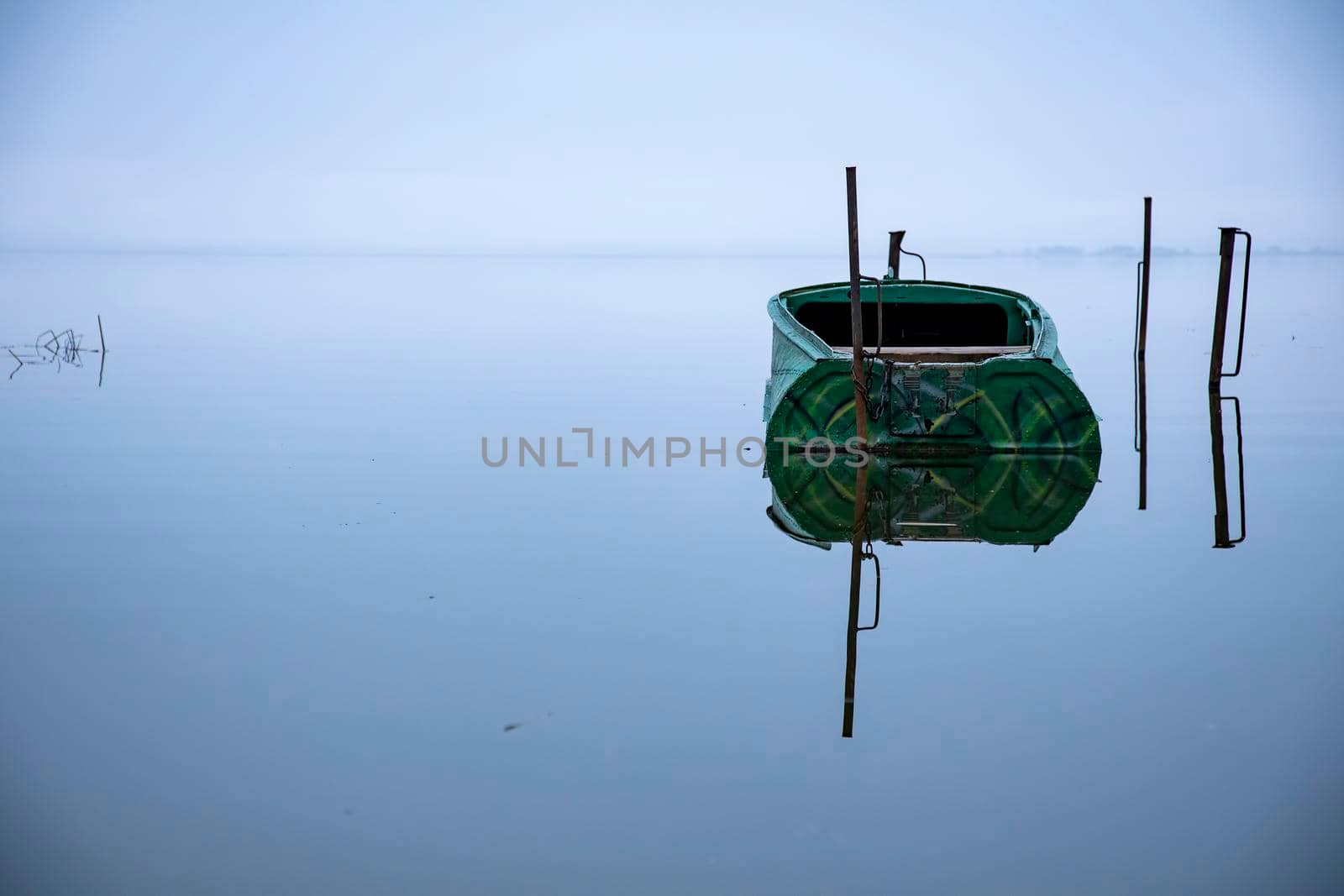 parked empty boat on the lake before sunrise. early morning landscape for fishing. no people