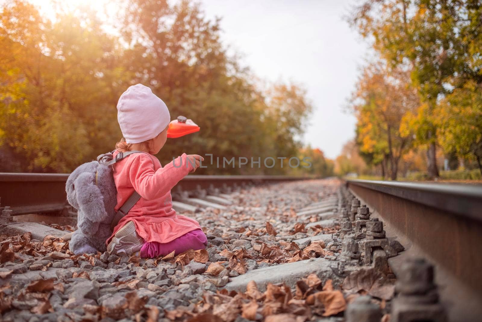 lifestyle. cute little girl plays outdoors on the abandoned railway tracks.