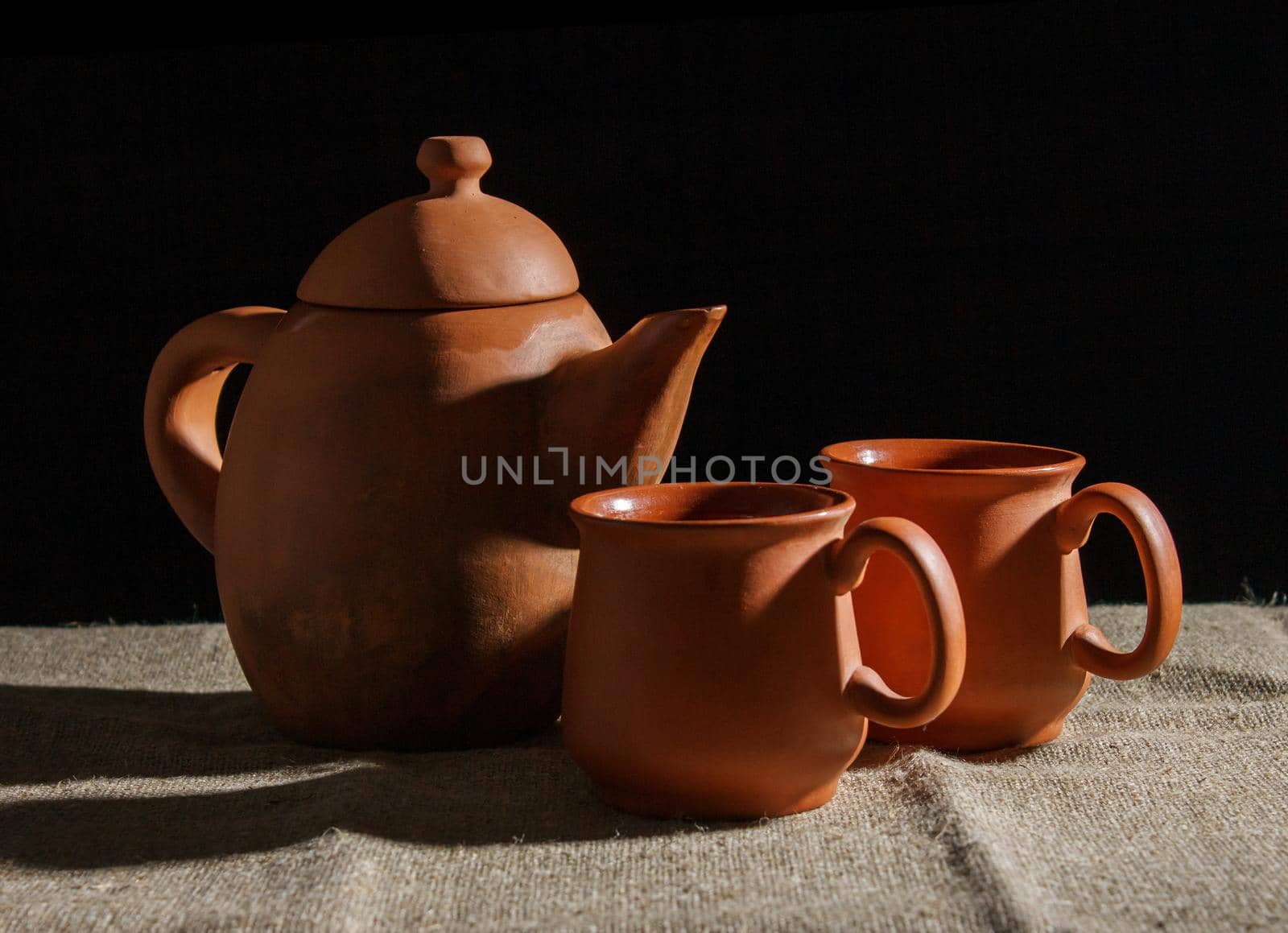 still life with a clay teapot and two cups by raddnatt