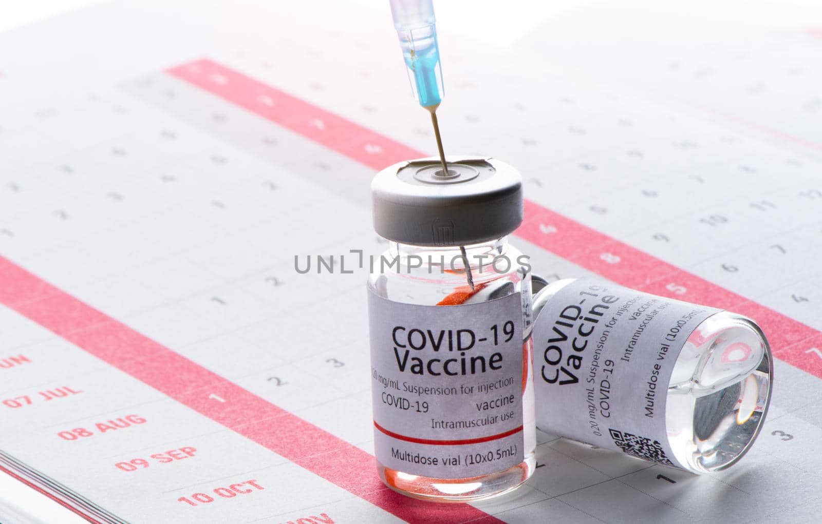 In the calendar, syringe with container of epidemic vaccine. by thanumporn