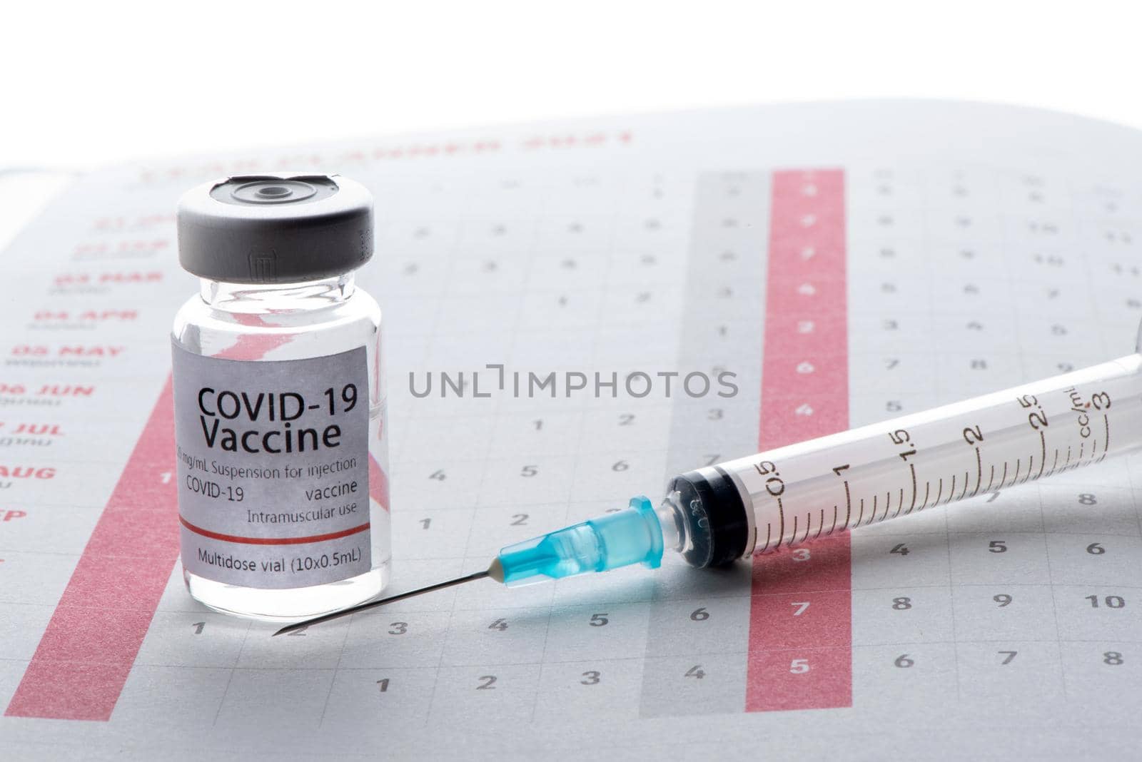 In the calendar, syringe with container of epidemic vaccine. by thanumporn