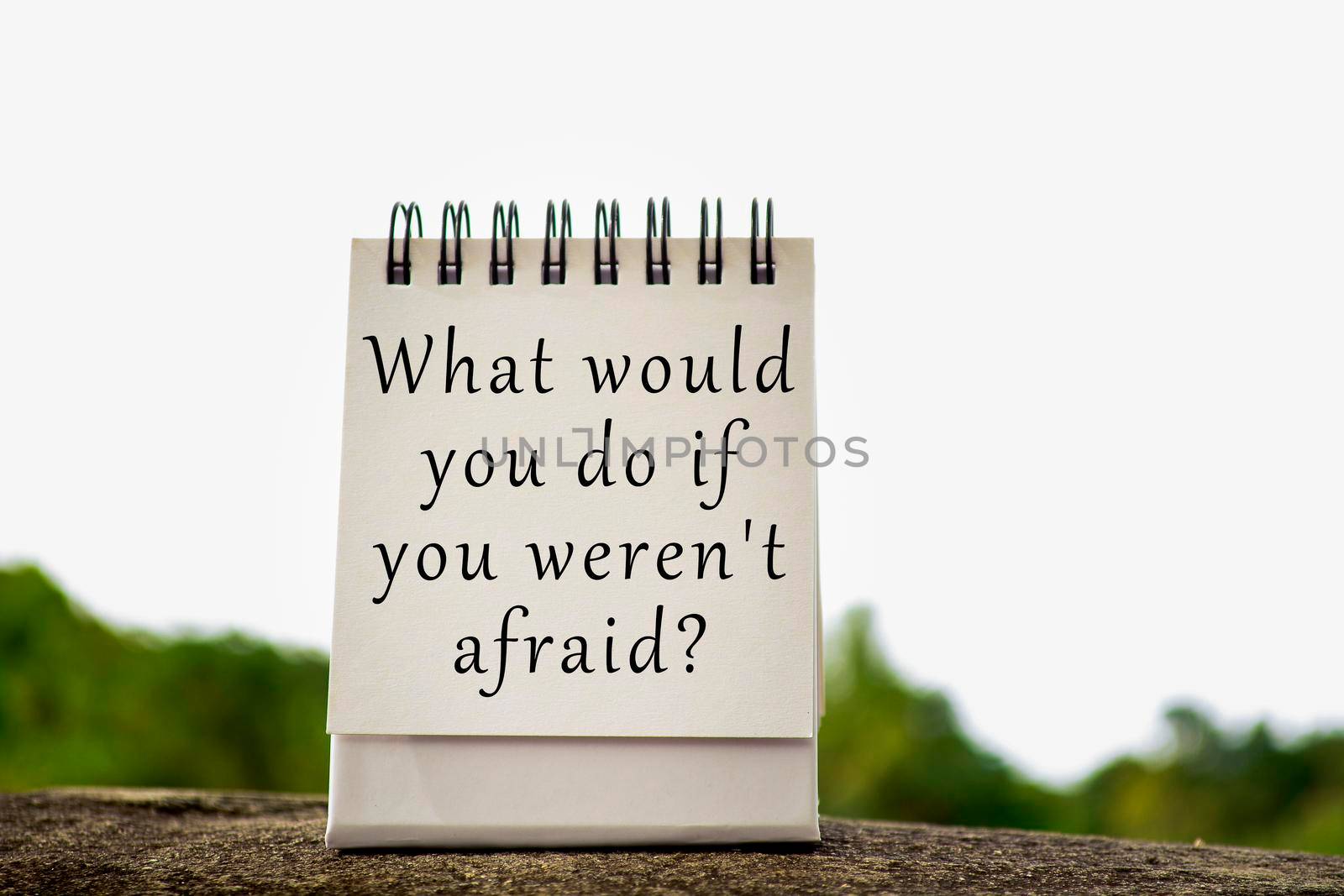 Motivational and inspirational quote with phrase on white stand paper