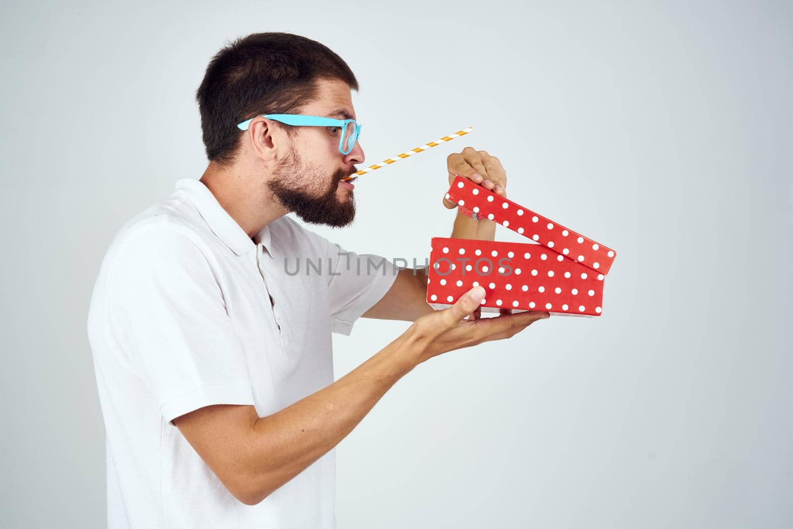 man wearing glasses gift box holiday fun light background. High quality photo