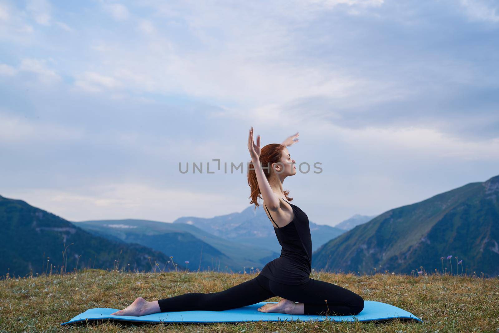 sportive woman workout meditation in the mountains outdoors by Vichizh
