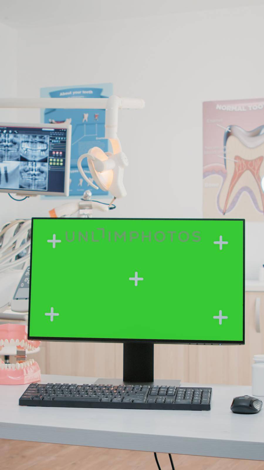 Nobody in dental cabinet with green screen on computer by DCStudio