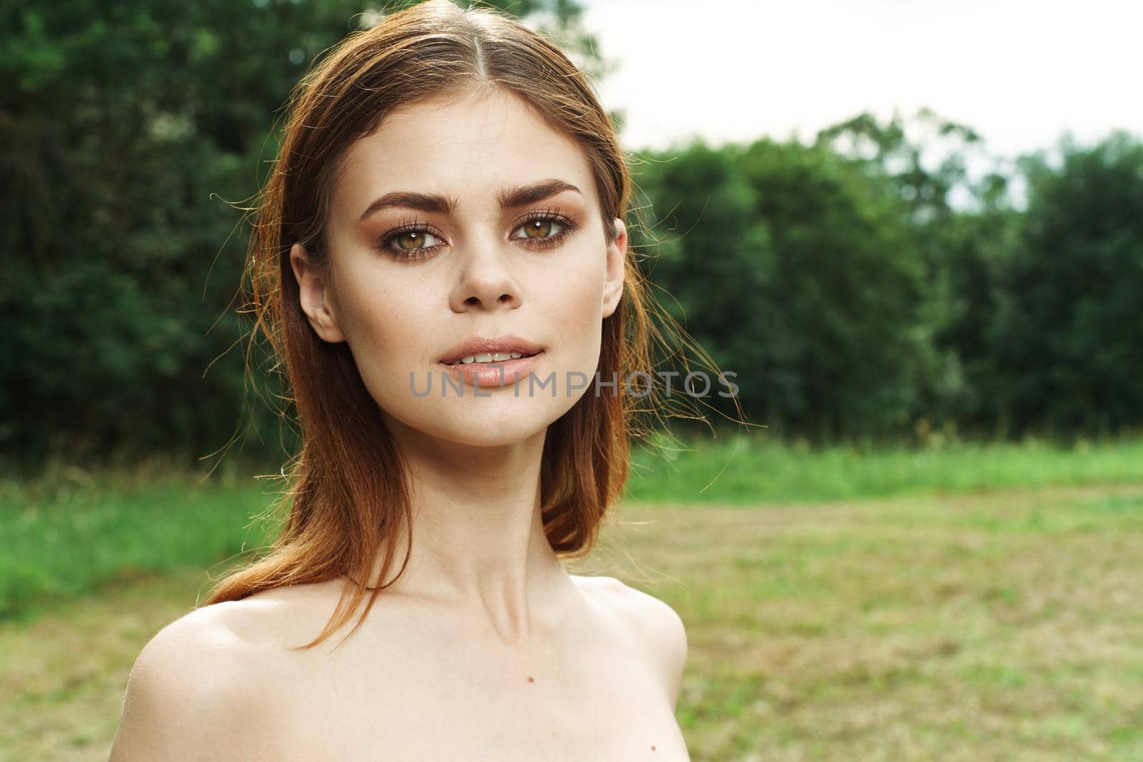 beautiful woman in a field outdoors bare shoulders clear skin cropped view by Vichizh