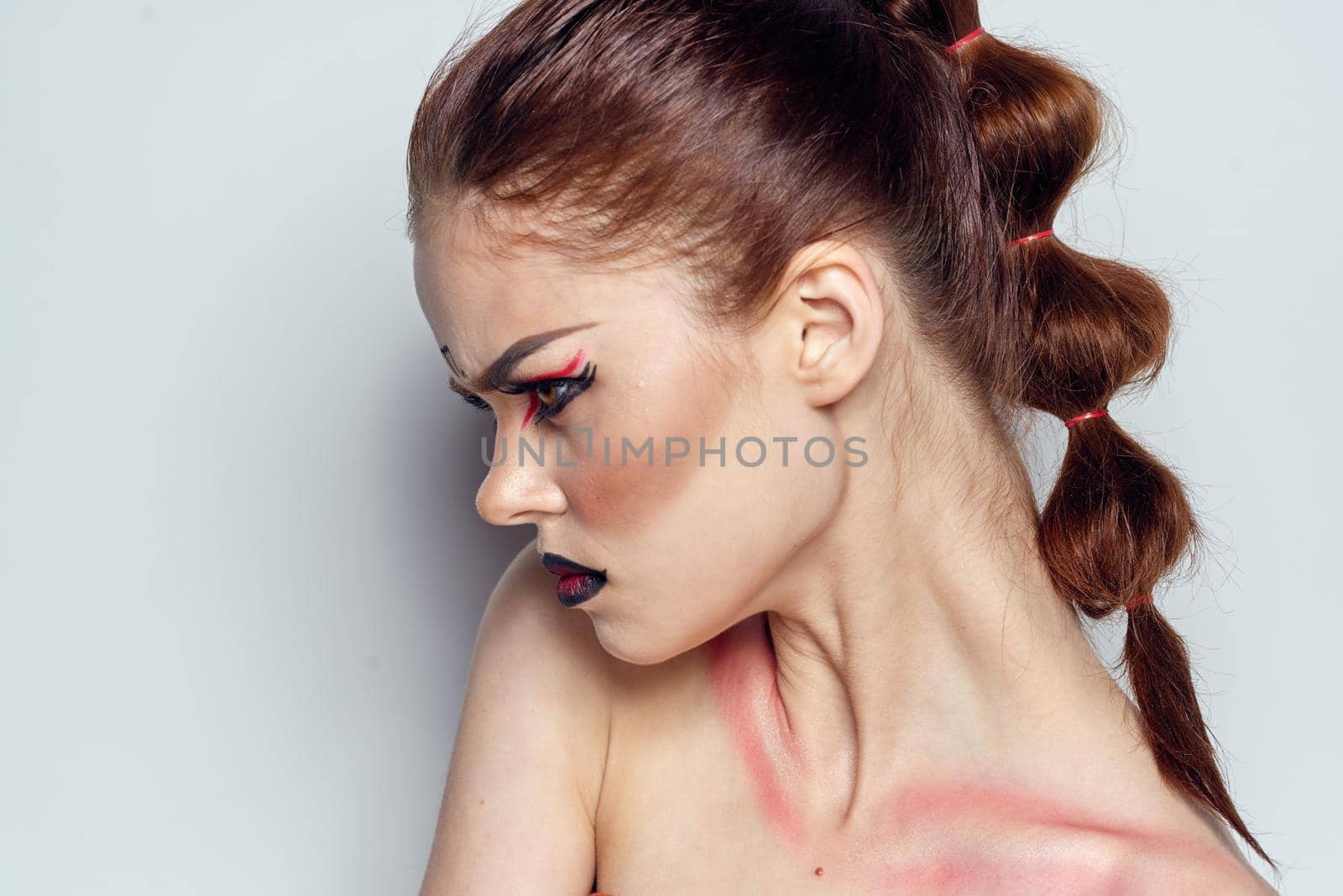 beautiful woman posing scorpio sign on forehead cosmetics light background. High quality photo