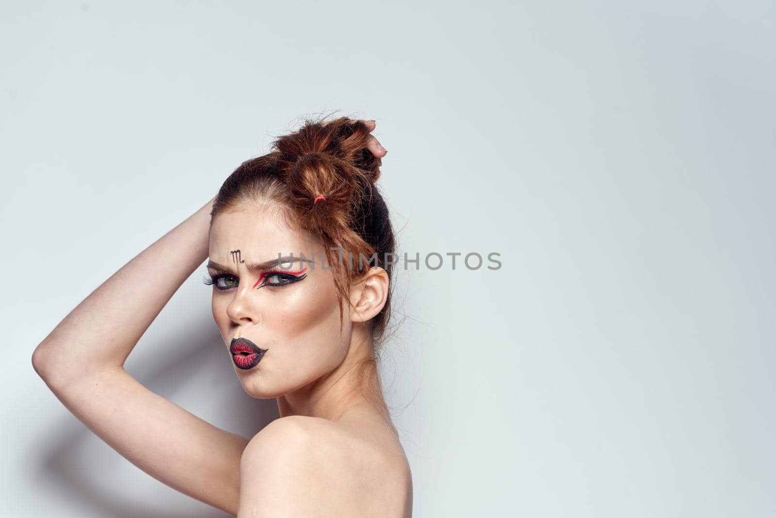 portrait of a woman naked shoulders cosmetics bright makeup color background. High quality photo