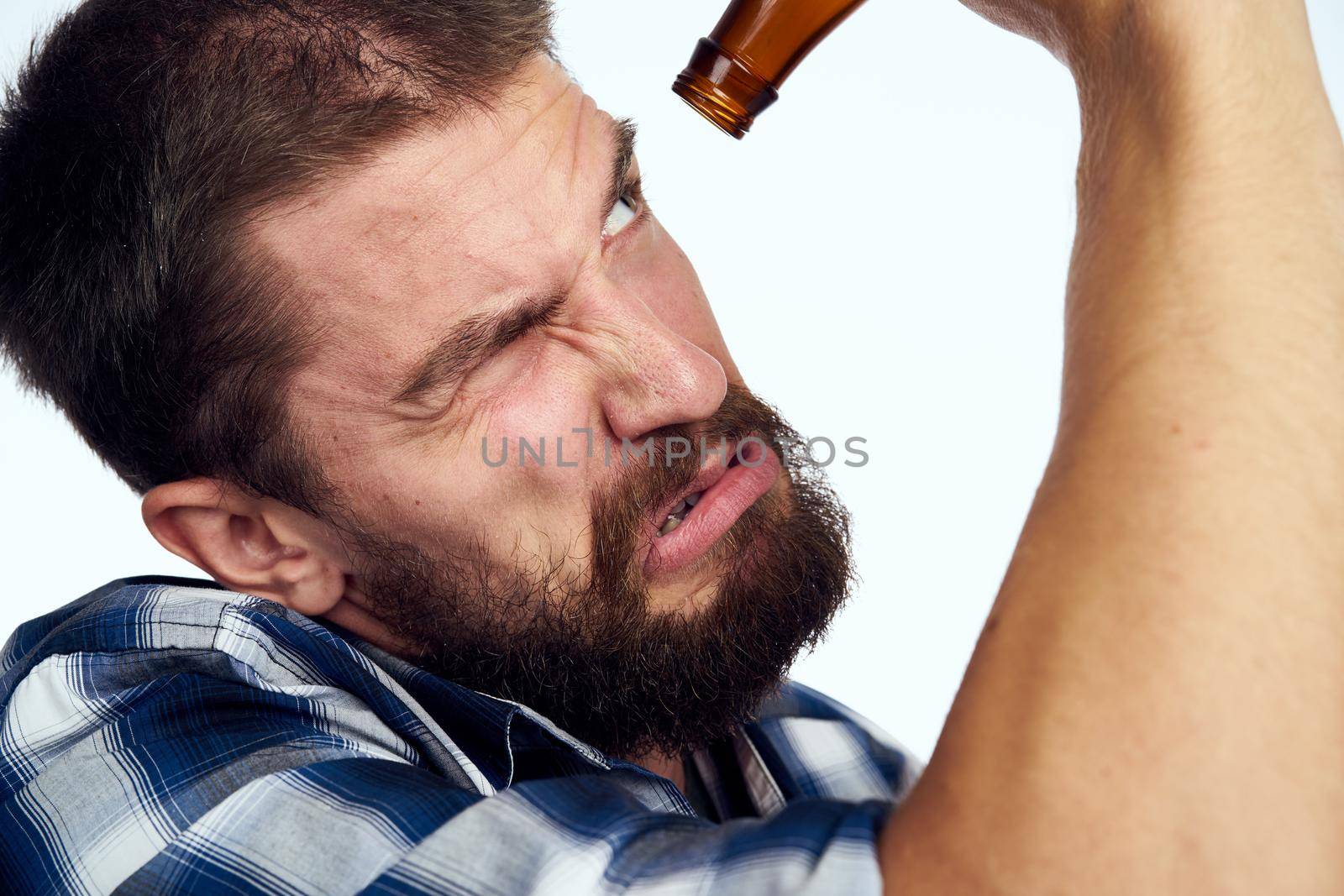 drunk man drinking beer alcohol emotion light background. High quality photo