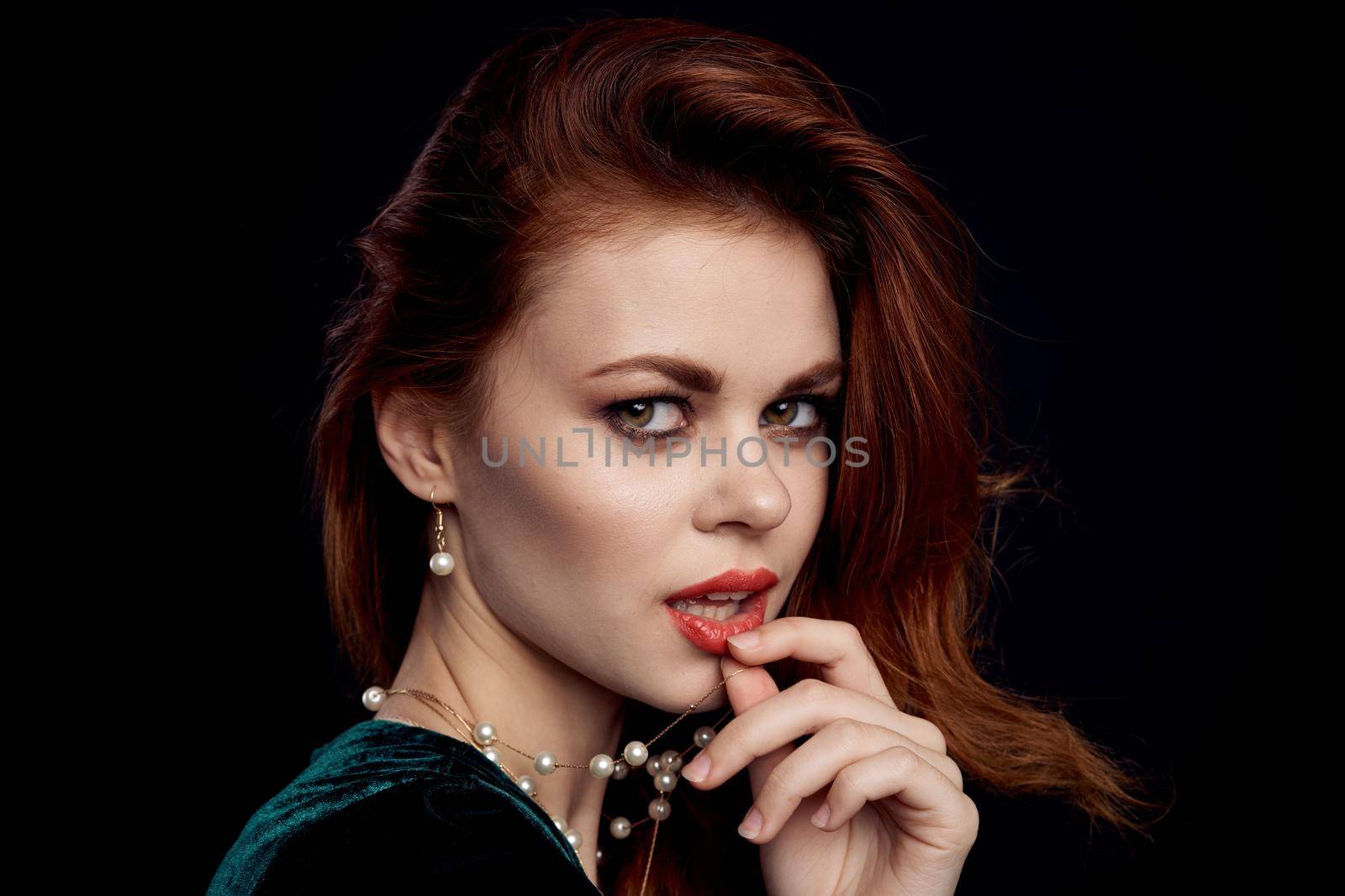 pretty woman green dress red lips charm Black background. High quality photo