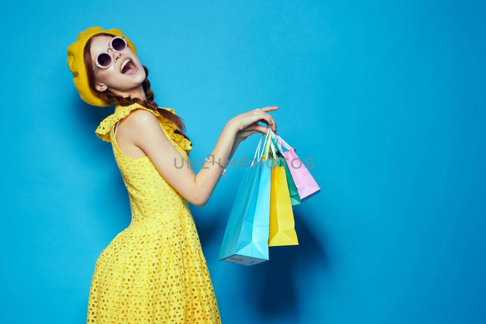 pretty woman with multicolored bags posing studio model. High quality photo