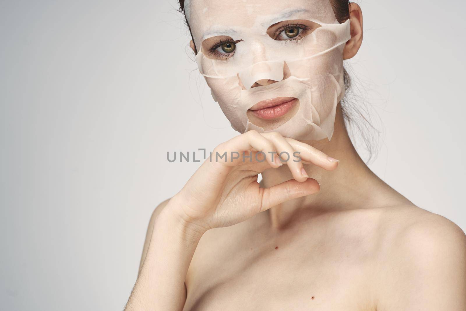 woman with bare shoulders face mask skin care procedures by Vichizh