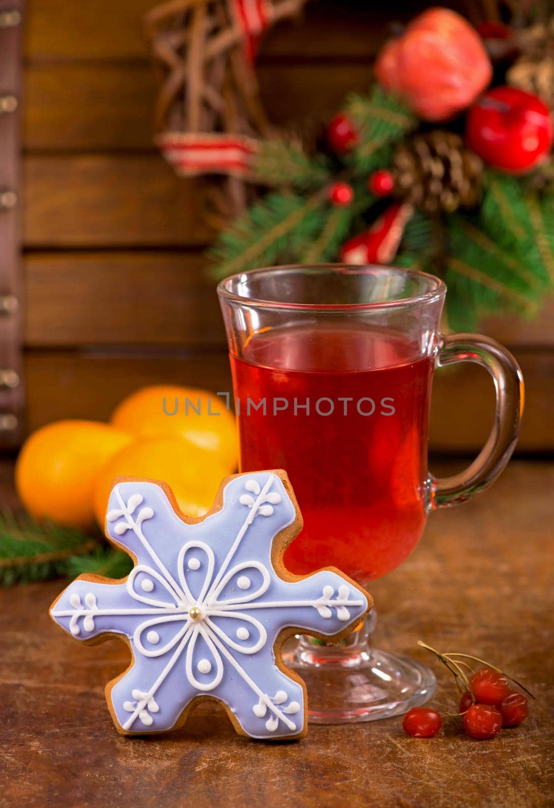 tea cup with spices and viburnum berries under evergreen branches