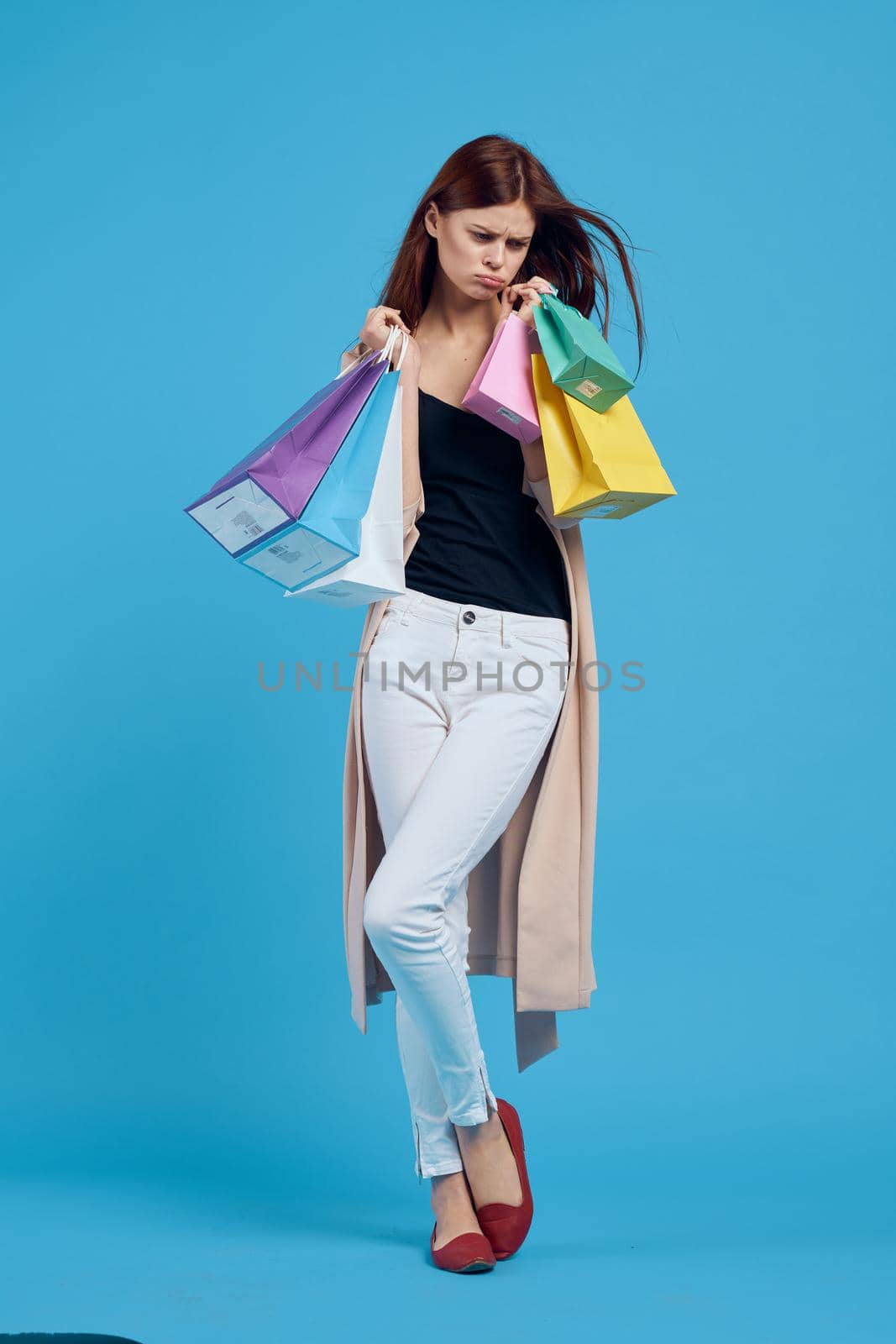 cheerful woman attractive look shopping smile summer style blue background. High quality photo