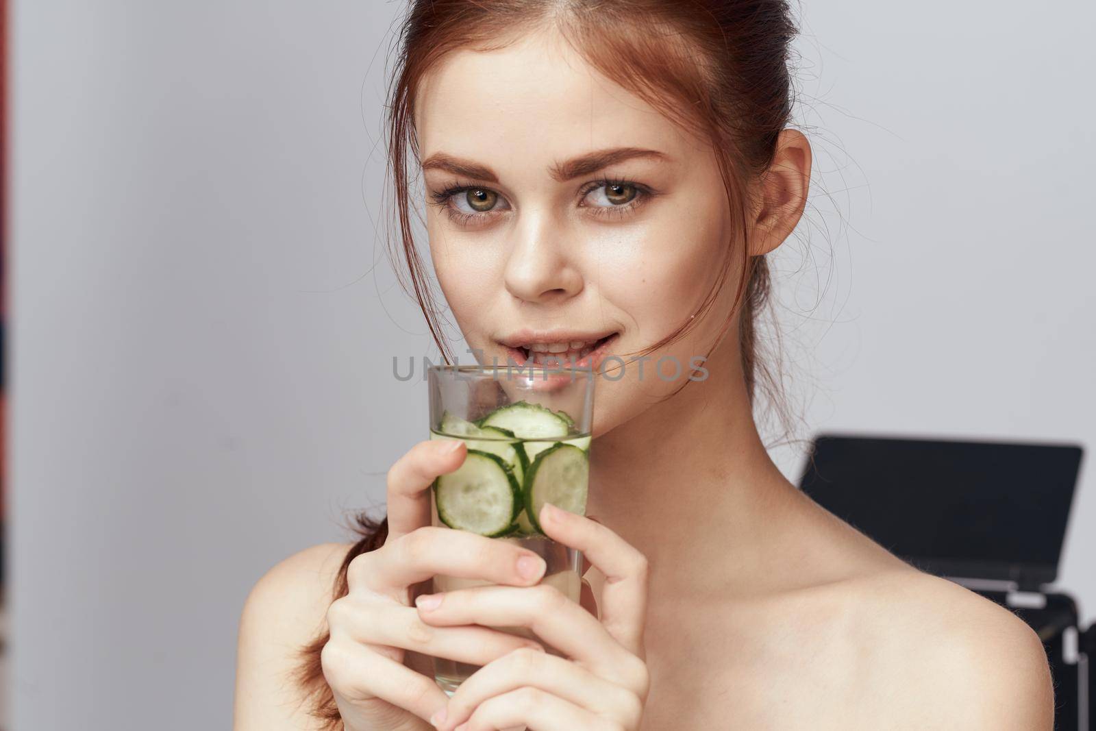 woman with bare shoulders cucumber health drink Fresh. High quality photo