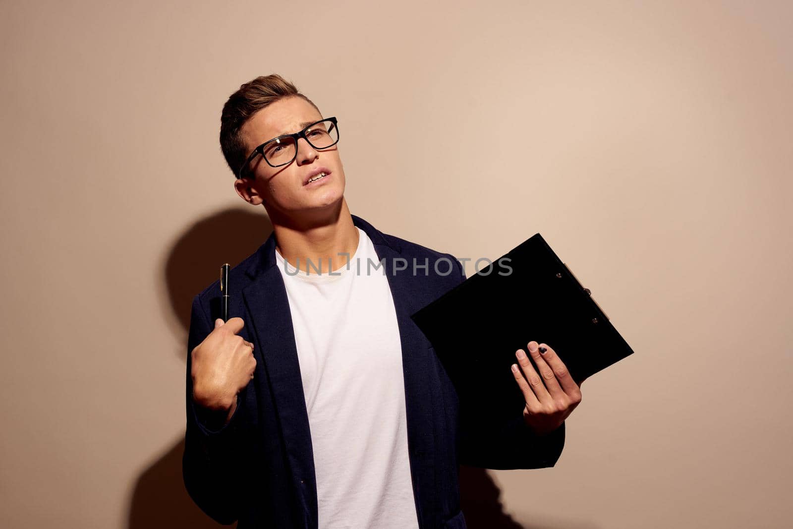 portrait of a man fashion posing with glasses beige background by Vichizh