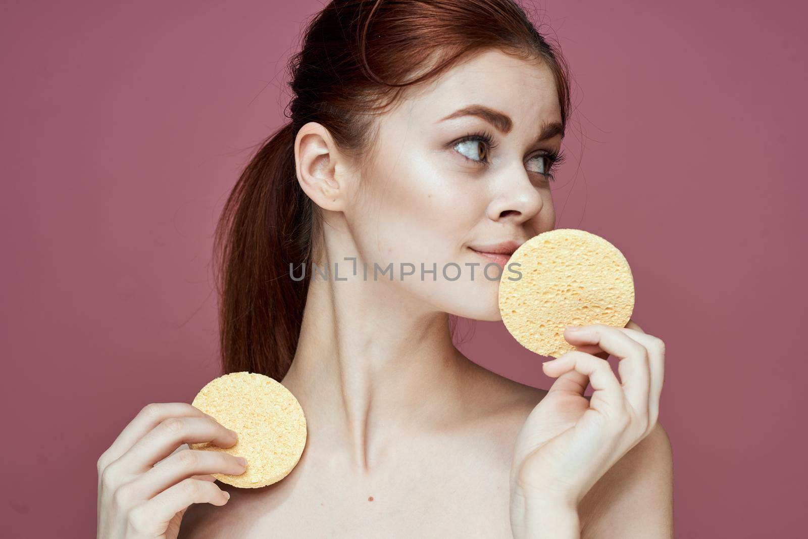 woman with bare shoulders sponge in hands clean skin hygiene. High quality photo