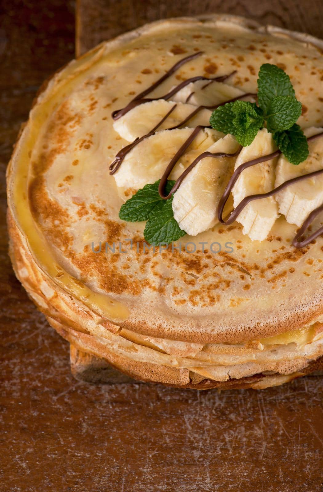 isolated desert - stack of pancake with banana on a wooden table by aprilphoto