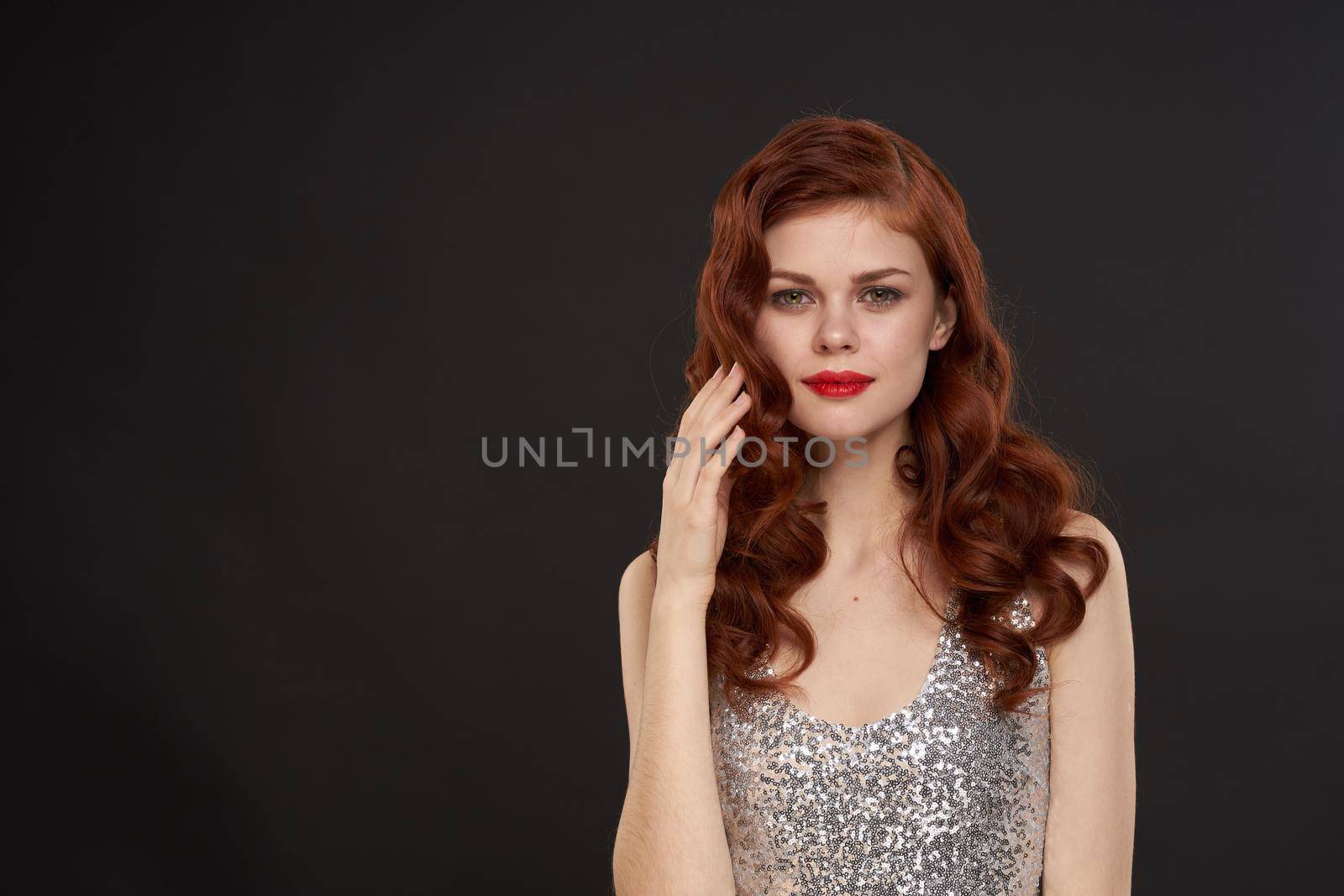 red-haired woman bright makeup glamor posing evening dresses. High quality photo