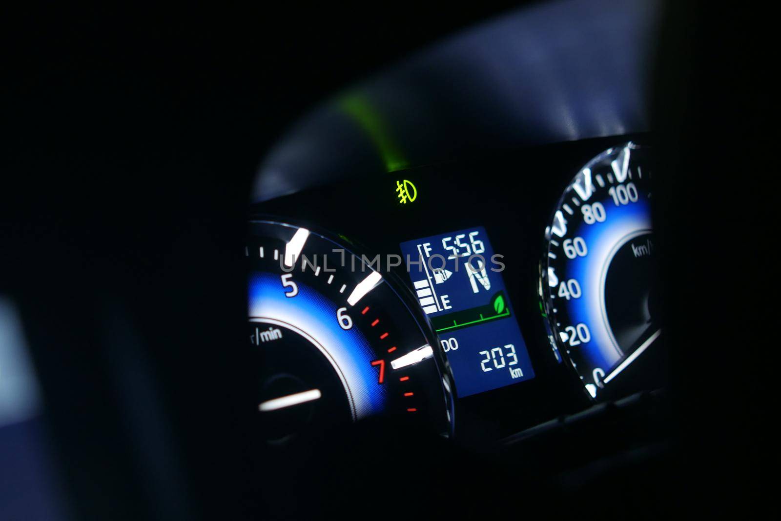 close up of car meter in dark