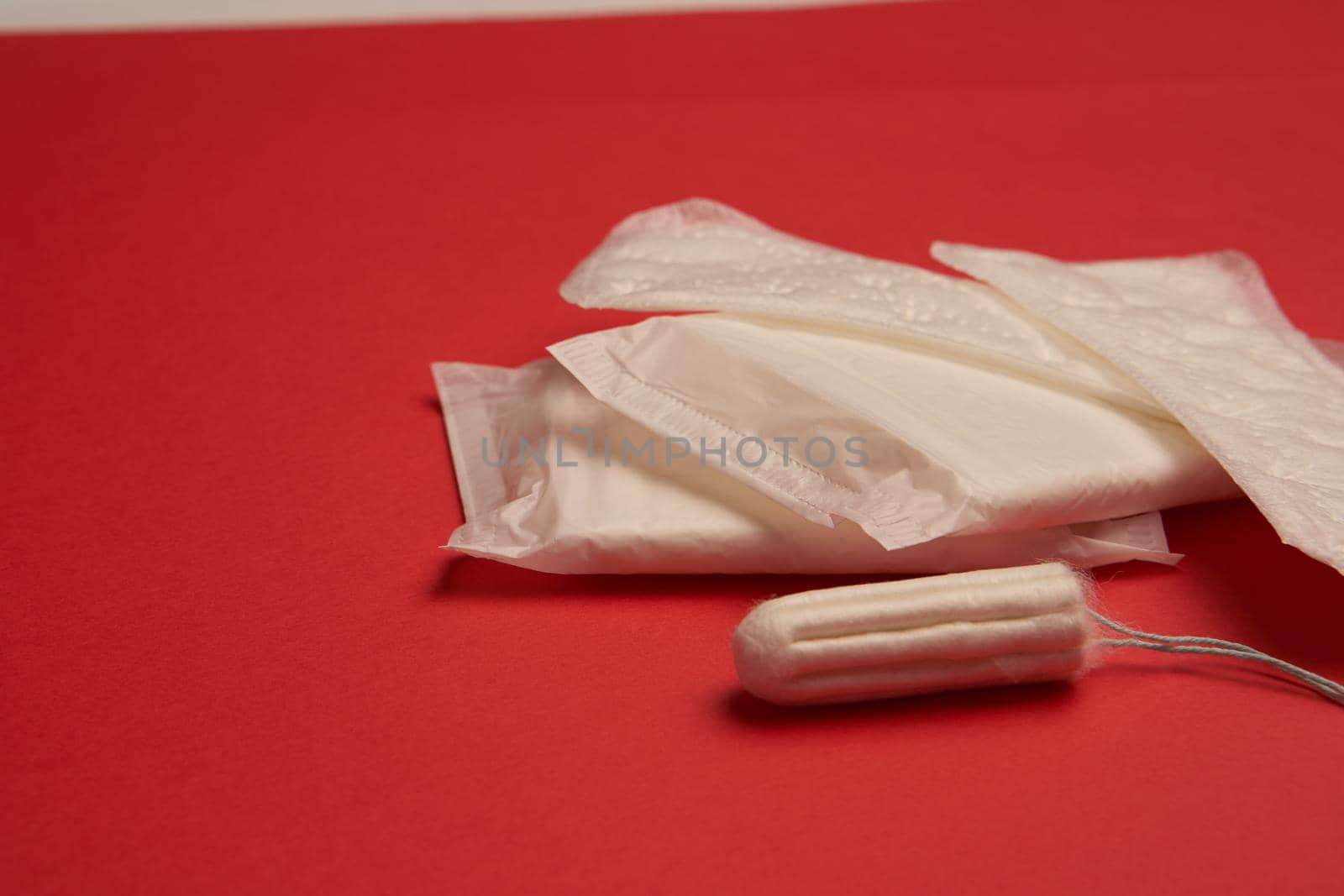 pads tampons underwear feminine hygiene red background by Vichizh