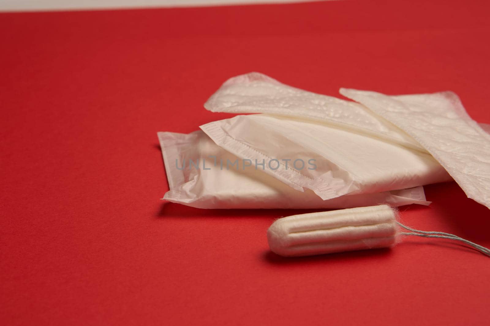 pads tampons underwear feminine hygiene red background. High quality photo