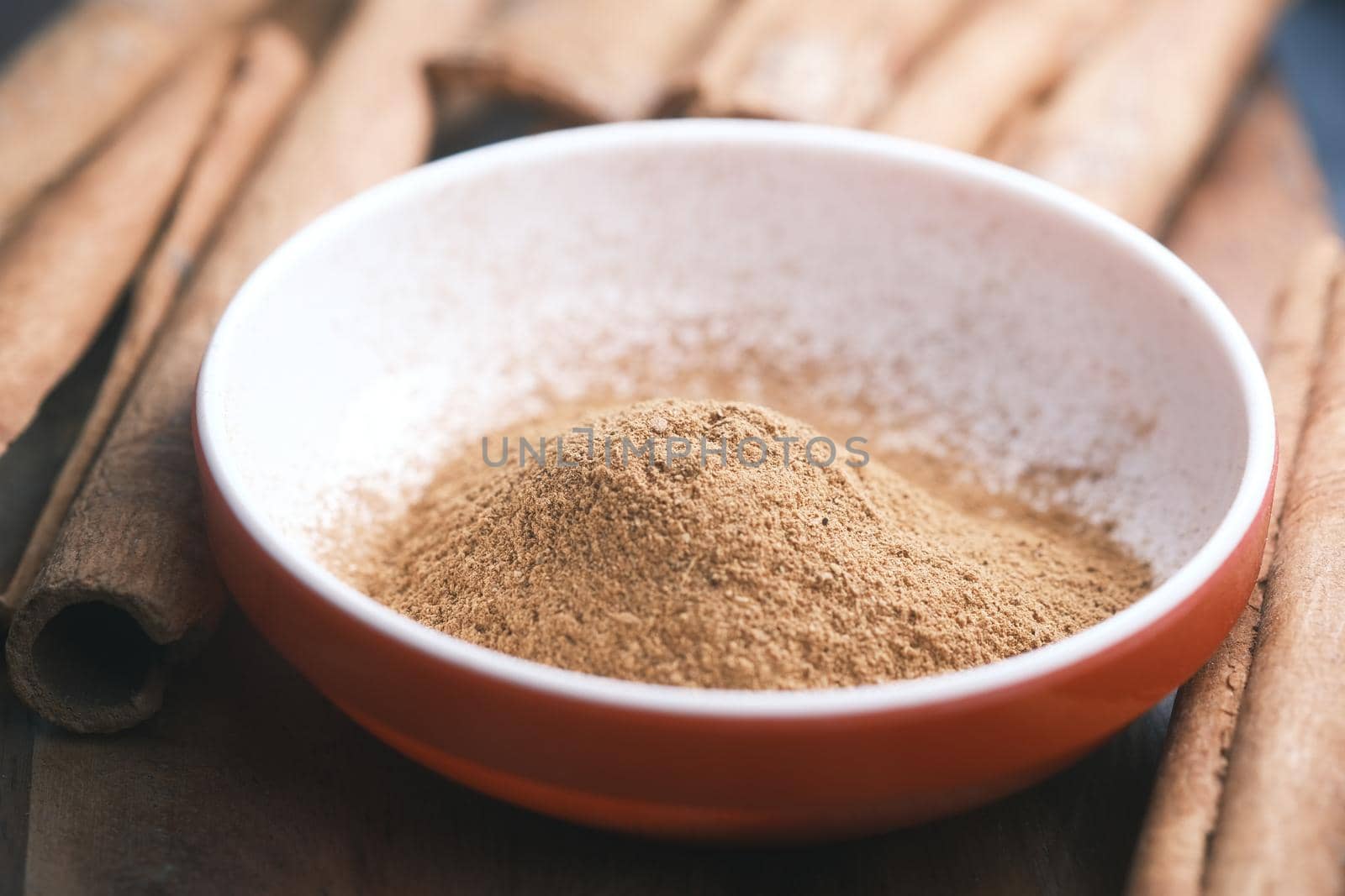 Cinnamon sticks and cinnamon powder on white background