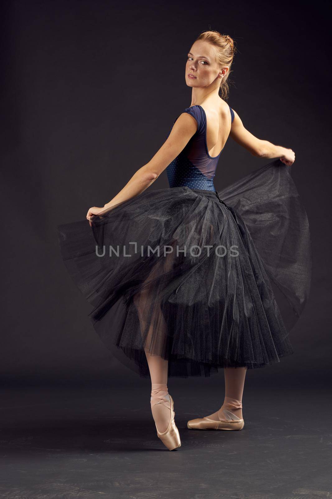 woman dancer elegant style art balance artist dark background. High quality photo