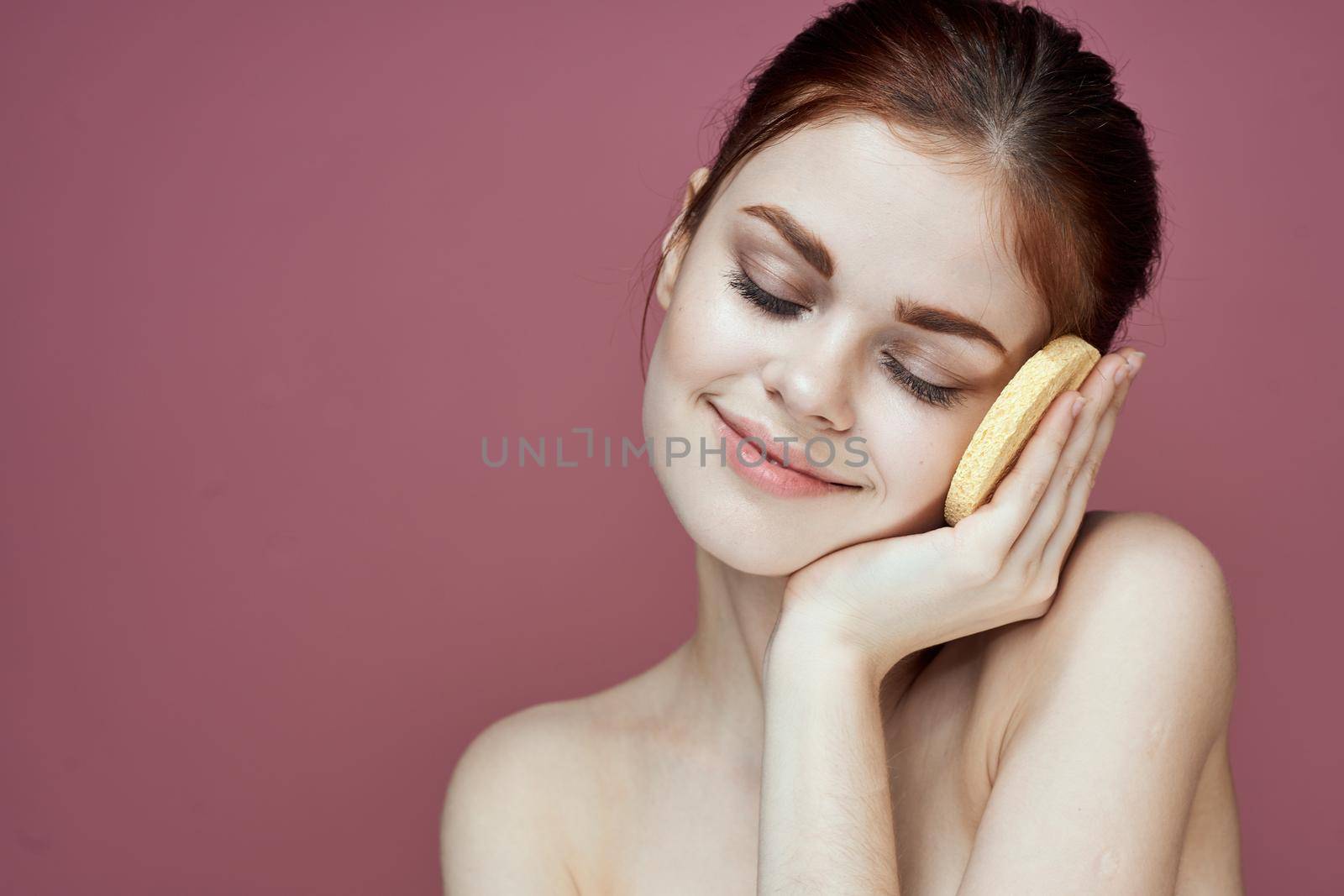 woman with bare shoulders sponge in hands clean skin hygiene. High quality photo