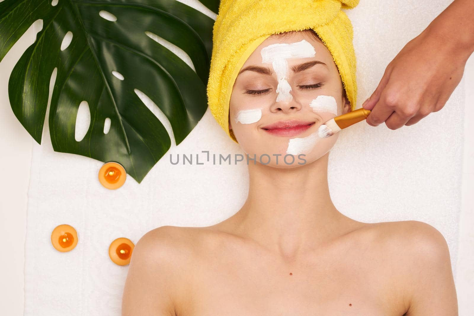 attractive woman face mask skin cleansing palm leaf light background by Vichizh