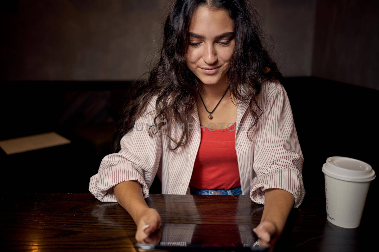 woman in restaurant sits by the table morning rest breakfast device. High quality photo