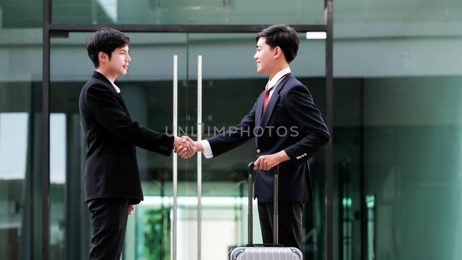 Businessmans handshake. Successful businessmen handshaking after good deal. Business partnership meeting concept.