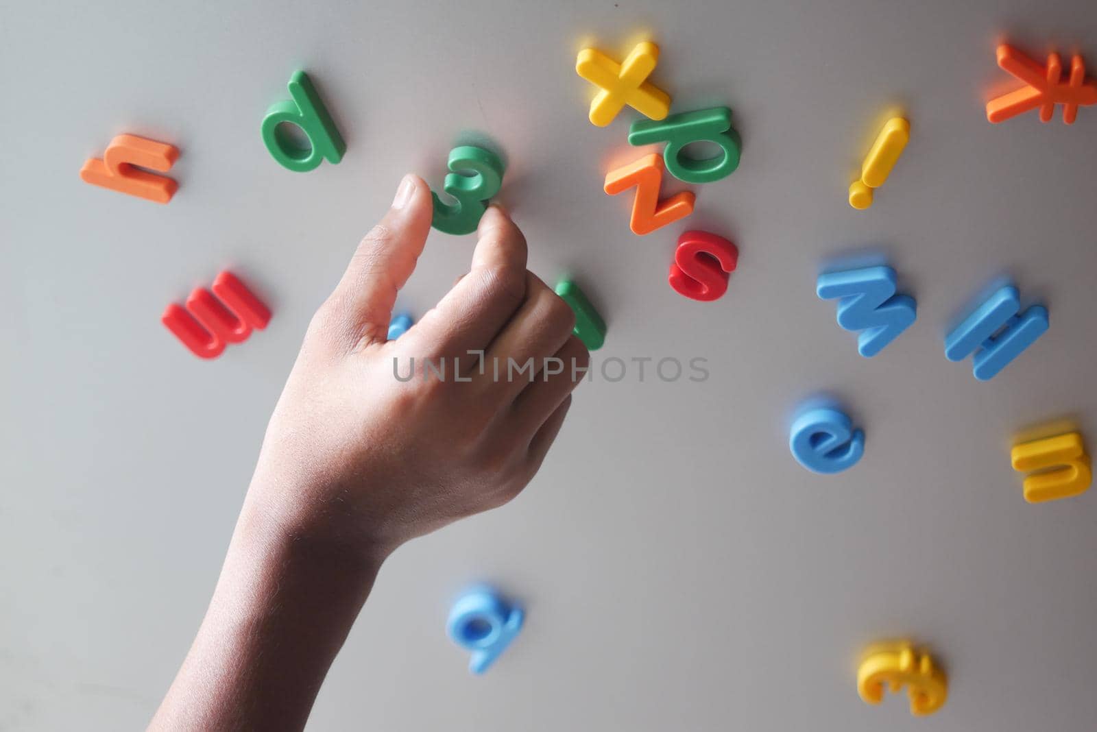 colorful plastic letters on orange background