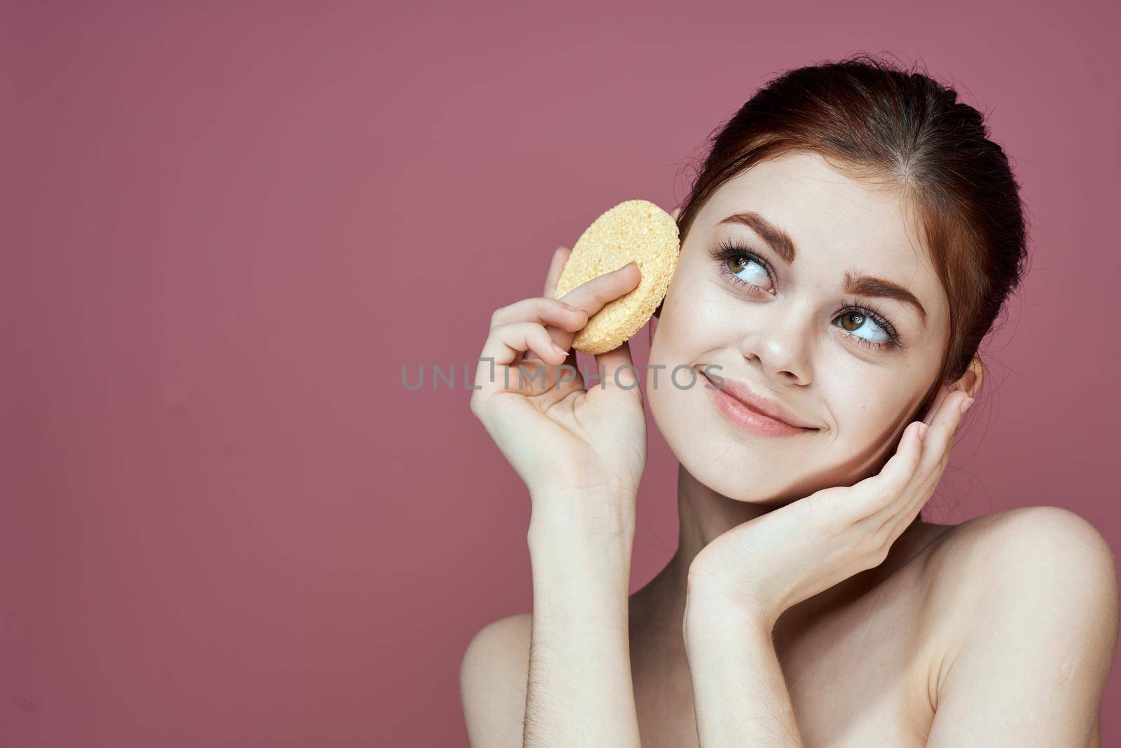 woman with bare shoulders sponge in hands clean skin hygiene. High quality photo