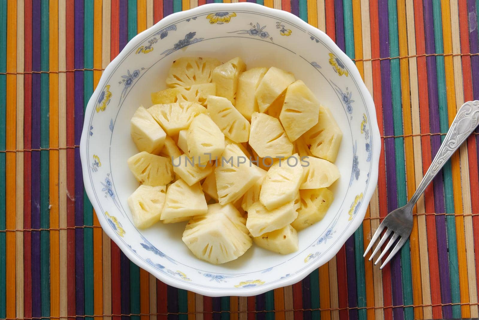 slice of pineapple in bowl on table .