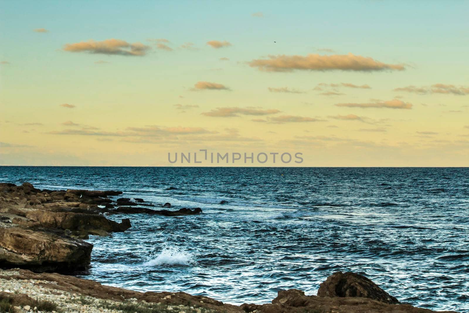 Colorful sunset on the beach in Autumn in Santa Pola, Alicante, Spain