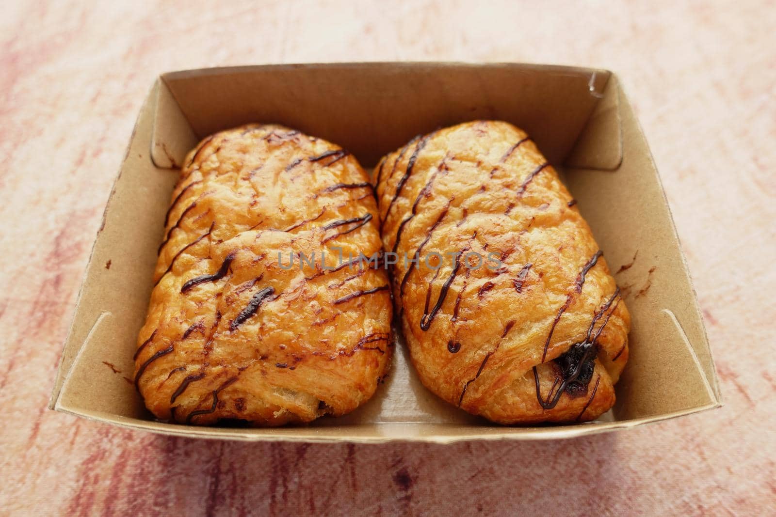 fresh baked croissant in a bow on table .