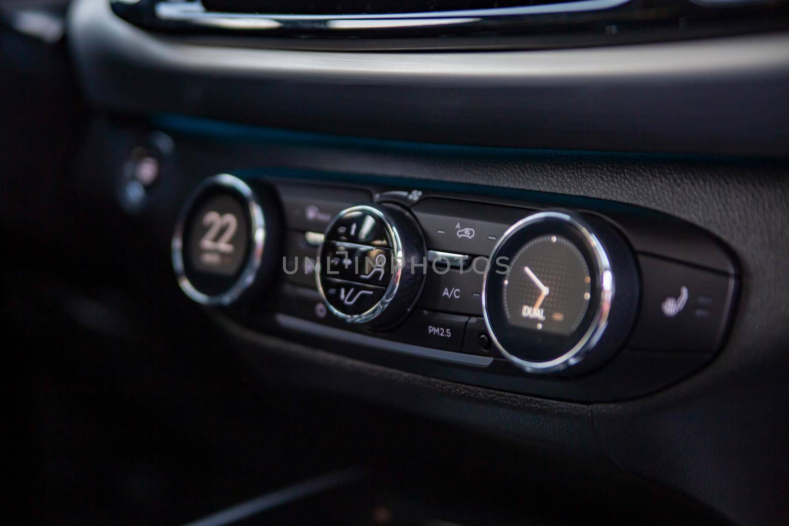 multimedia control console and climate in a modern premium car. close-up, selective focus, no people