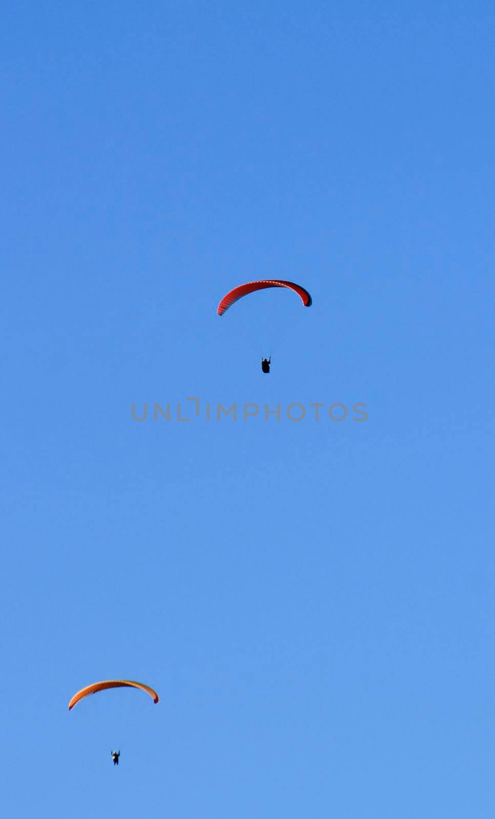 People paragliding in Santa Pola on a sunny day of Autumn