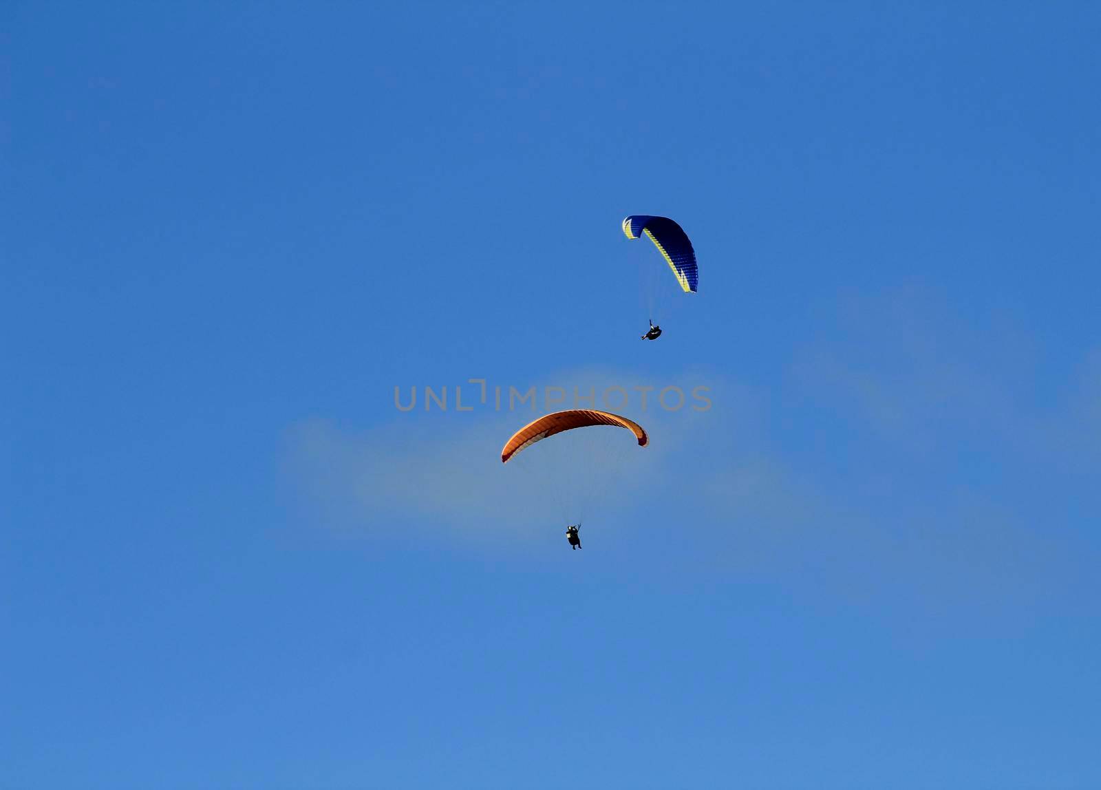 People paragliding in Santa Pola on a sunny day of Autumn