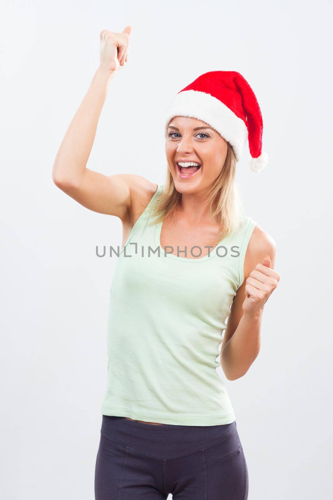 Happy fit woman with Santa hat.