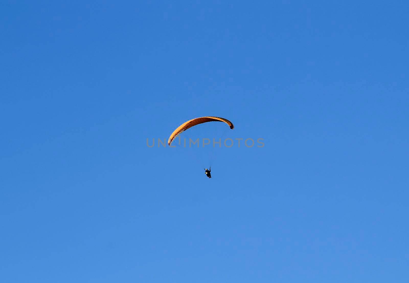 People paragliding in Santa Pola on a sunny day of Autumn