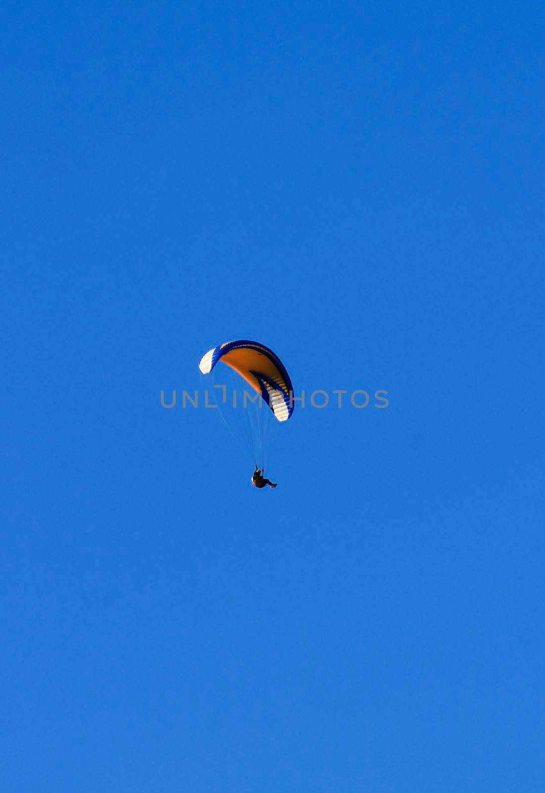 People paragliding in Santa Pola on a sunny day of Autumn